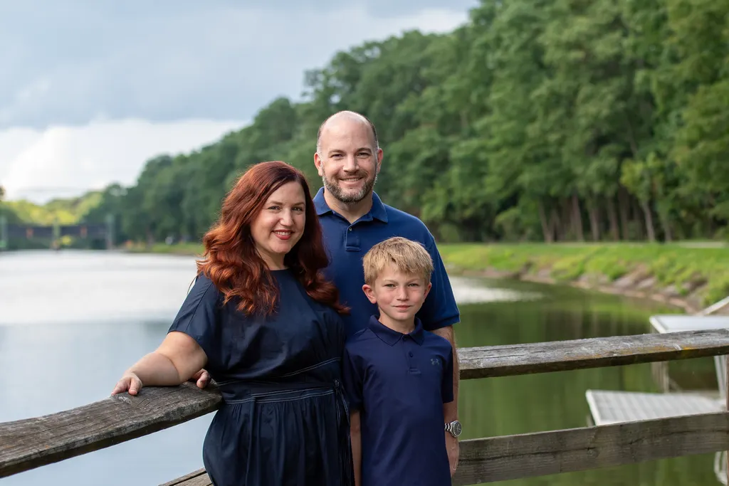 Jen Lunsford with her husband and son at a railing along the Erie Canal