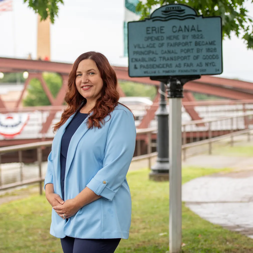 Jen Lunsford beside the Erie Canal historical marker in the Village of Fairport