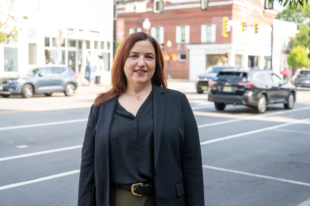 Jen Lunsford standing outdoors on a neighborhood street in the district